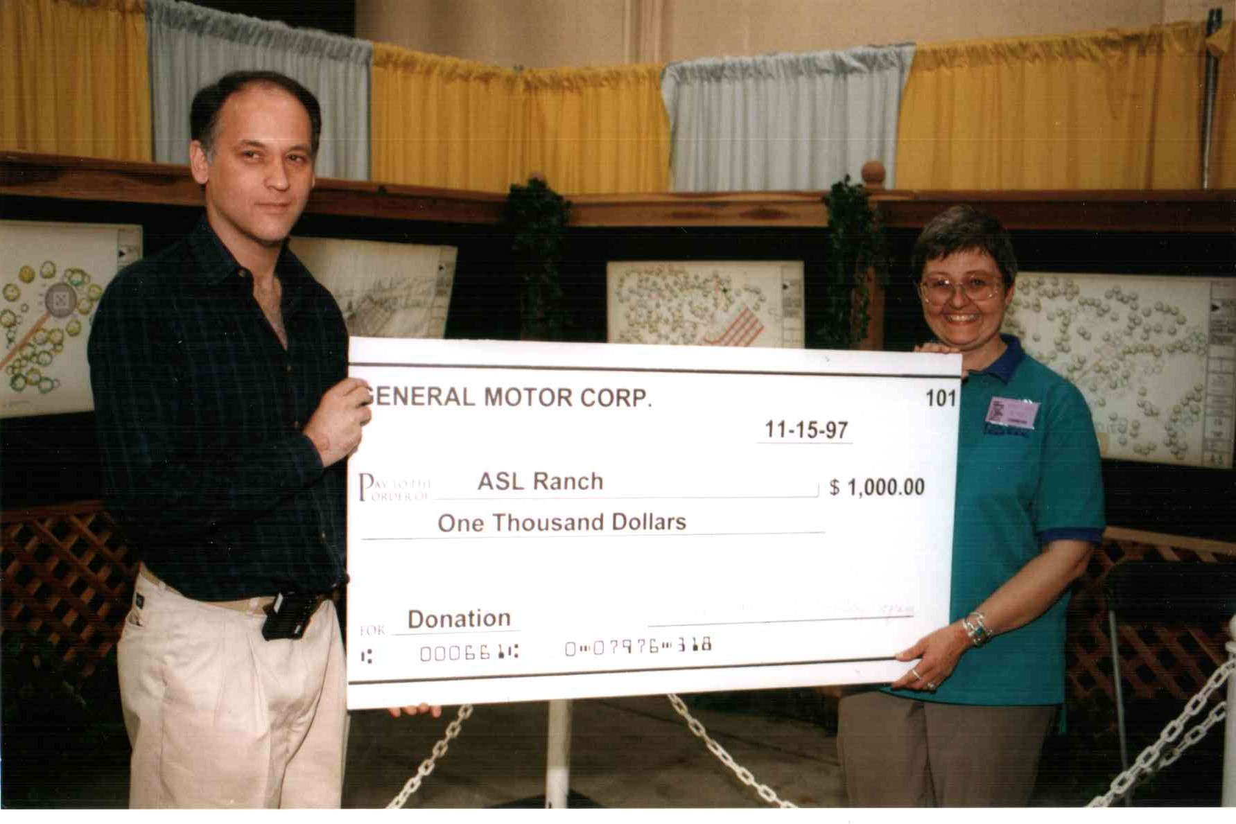 General Motors representative presents $1,000 check to kick off 1997 fundraising drive.